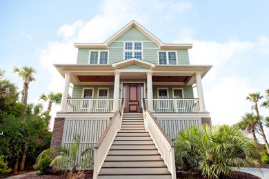Large beach style green three-story vinyl gable roof photo in Charleston