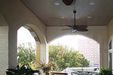 This is an example of a mid-sized traditional back porch design in Other with decking and a roof extension.