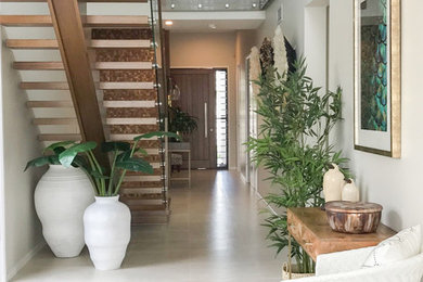Photo of a mid-sized tropical hallway in Gold Coast - Tweed with white walls, porcelain floors and white floor.