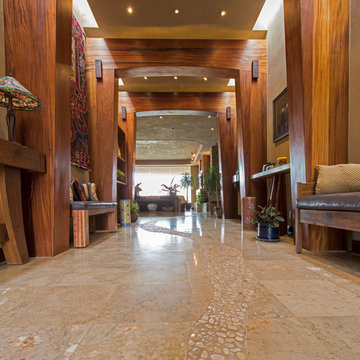 Entrada Home, polished travertine floor with pebble pathway