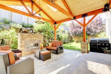Inspiration for a large transitional backyard stone patio remodel in Los Angeles with a gazebo