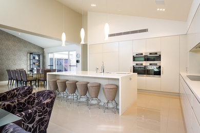 This is an example of a contemporary eat-in kitchen in Sydney with with island.