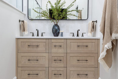 Inspiration for a coastal mosaic tile floor, multicolored floor and double-sink bathroom remodel in Chicago with shaker cabinets, light wood cabinets, white walls, white countertops and a built-in vanity