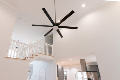 Example of a huge open concept living room design with white walls