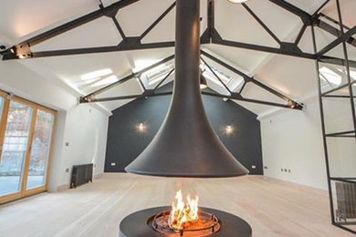 Design ideas for a contemporary living room in Kent with a hanging fireplace.