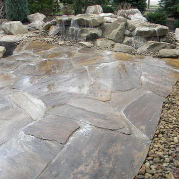 Carved stone water feature pondless and stone patio