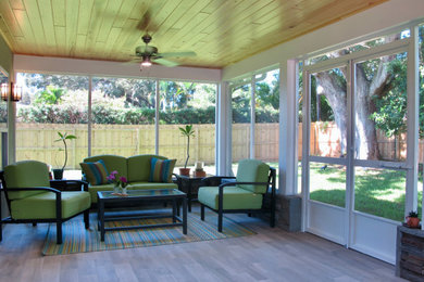 Mid-sized transitional tile screened-in back porch idea in Tampa with a roof extension