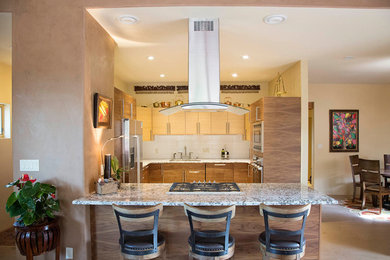 Eat-in kitchen - large contemporary u-shaped light wood floor eat-in kitchen idea in Albuquerque with a double-bowl sink, flat-panel cabinets, light wood cabinets, marble countertops, white backsplash, subway tile backsplash, stainless steel appliances and no island