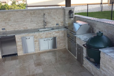 Example of a mid-sized classic backyard concrete patio kitchen design in Austin with a pergola