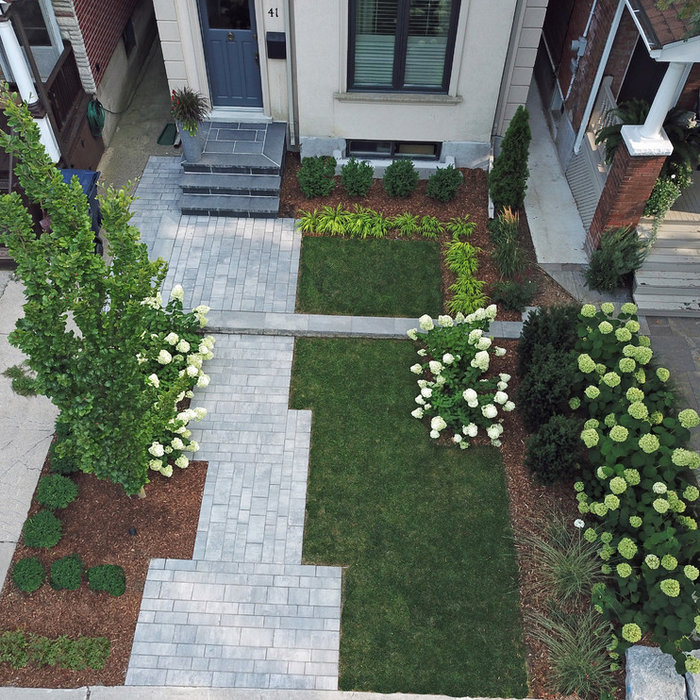 Inspiration for a mid-sized modern partial sun front yard concrete paver landscaping in Toronto for summer.