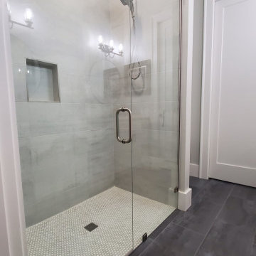 Elegant Shower done with 12x24 tiles and penny rounds.