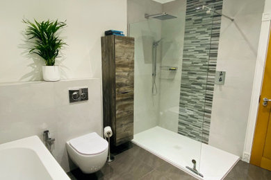 Inspiration for a large modern grey and brown family bathroom in Other with flat-panel cabinets, brown cabinets, a corner bath, a walk-in shower, a wall mounted toilet, porcelain tiles, grey walls, porcelain flooring, an integrated sink, grey floors, an open shower, a single sink and a floating vanity unit.