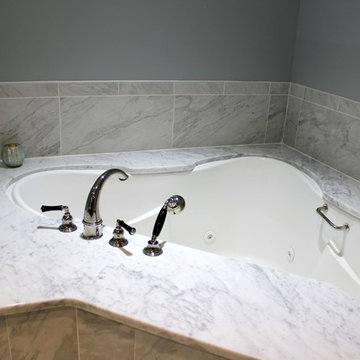 Master Bathroom Corner Whirlpool Tub with Carrera Marble Surround