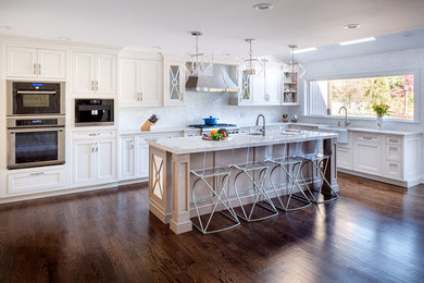 Kitchen pantry - large transitional l-shaped dark wood floor kitchen pantry idea in New York with a farmhouse sink, beaded inset cabinets, white cabinets, quartzite countertops, multicolored backsplash, mosaic tile backsplash and paneled appliances