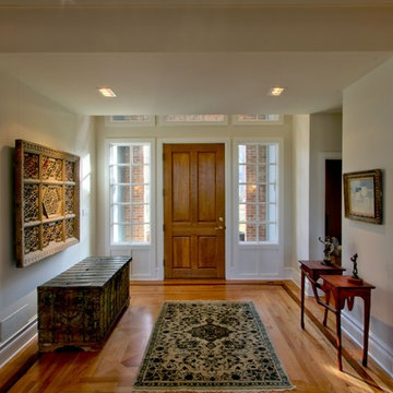 Entryway with Gallery Lighting to Highlight Artwork and Transom Entry Door