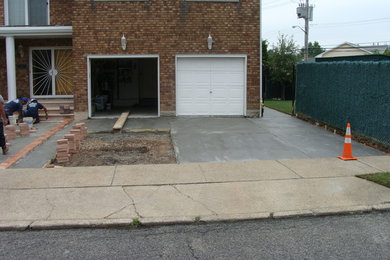 Inspiration for a mid-sized modern full sun front yard concrete paver driveway in New York.