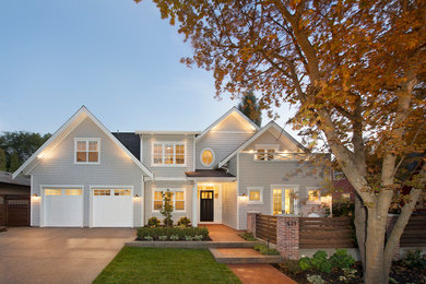 Example of a huge beach style beige two-story wood gable roof design in Vancouver