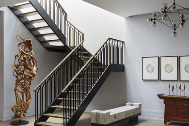 Contemporary wood u-shaped staircase in Chicago with open risers and metal railing.