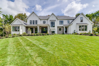 Large farmhouse white two-story wood house exterior idea in Cleveland with a hip roof and a mixed material roof