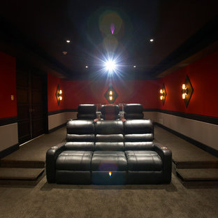 Example of a mid-sized classic enclosed carpeted home theater design in Chicago with a projector screen and red walls