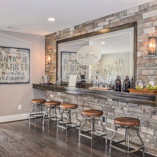 Design ideas for a medium sized traditional walk-out basement in DC Metro with grey walls, dark hardwood flooring and a tiled fireplace surround.