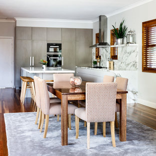 Large transitional open plan dining in Sydney with medium hardwood floors and multi-coloured floor.