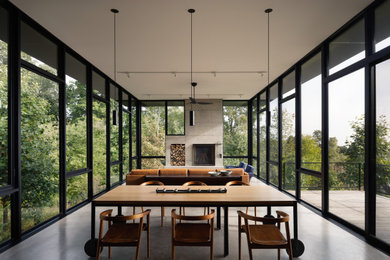 Minimalist concrete floor and gray floor great room photo in DC Metro