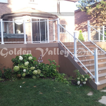 azek deck with big stiar and glass panel railing