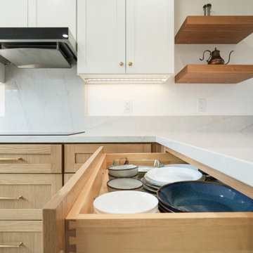 Modern White and Natural Oak Kitchen with Brass Hardware and Quartz Backsplash