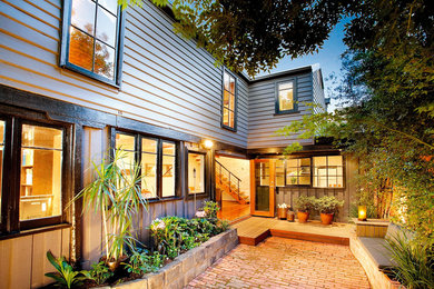 Photo of a transitional exterior in Melbourne with wood siding.