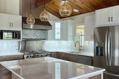 Open concept kitchen - mid-sized coastal l-shaped exposed beam open concept kitchen idea in Raleigh with an undermount sink, shaker cabinets, light wood cabinets, quartz countertops, white backsplash, marble backsplash, stainless steel appliances, an island and white countertops