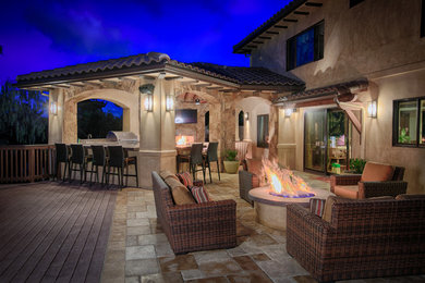 Mid-sized mediterranean backyard patio in San Diego with an outdoor kitchen, concrete pavers and a roof extension.
