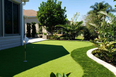 This is an example of a contemporary backyard concrete paver landscaping in Orlando.