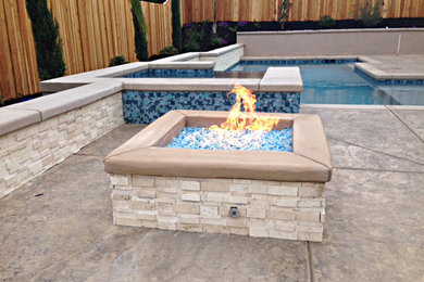 Mid-sized trendy backyard stamped concrete patio photo in Sacramento with a fire pit and no cover