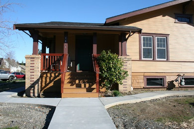 Example of a small arts and crafts beige one-story wood exterior home design in Seattle