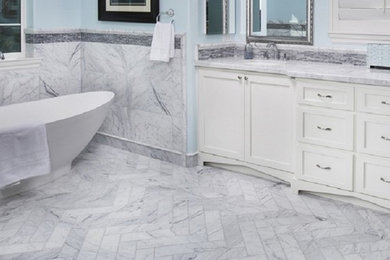 Inspiration for a mid-sized transitional master gray tile, white tile and marble tile marble floor and white floor bathroom remodel in San Diego with recessed-panel cabinets, white cabinets, an undermount sink, quartzite countertops, a hinged shower door and white walls