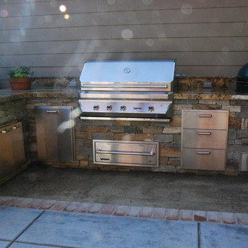 Outdoor kitchen including sink, storage and trash drawers, Twin Eagles gas grill