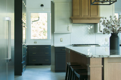Kitchen - large u-shaped kitchen idea in Other with shaker cabinets, white cabinets and an island