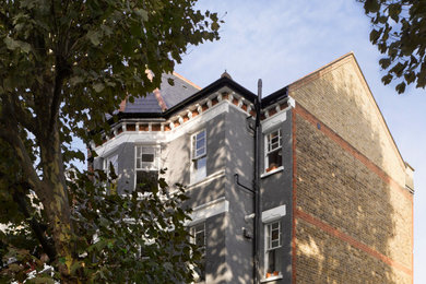 Inspiration for a medium sized and multi-coloured classic brick and front house exterior in London with four floors, a pitched roof, a tiled roof and a grey roof.