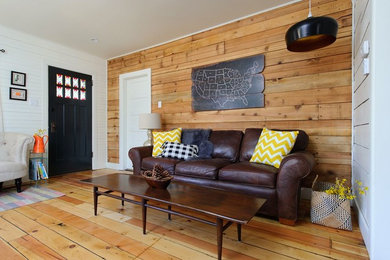 Example of a trendy enclosed medium tone wood floor living room design in Other with white walls