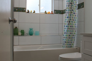 Photo of a bathroom in Other with shaker cabinets, white cabinets, an undermount sink, a shower curtain and white benchtops.