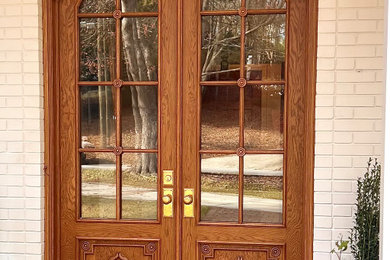 Large tuscan brick floor and red floor entryway photo in Atlanta with white walls and a medium wood front door