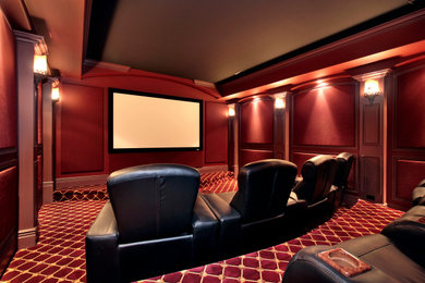 Inspiration for a mid-sized timeless enclosed carpeted and red floor home theater remodel in Philadelphia with red walls and a projector screen