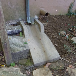 Downspout damaging footer needed some custom concrete wash and footer support - Products
