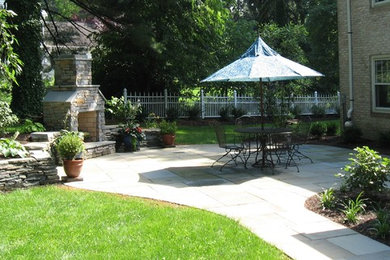 Inspiration for a mid-sized timeless backyard stone patio remodel in Philadelphia with a fire pit and no cover