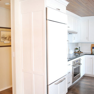 Paneled refrigerator door and drawer with lift-up door above