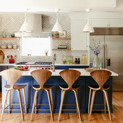Inspiration for a large transitional l-shaped medium tone wood floor and brown floor enclosed kitchen remodel in Denver with recessed-panel cabinets, blue cabinets, gray backsplash, porcelain backsplash, stainless steel appliances, an island and white countertops