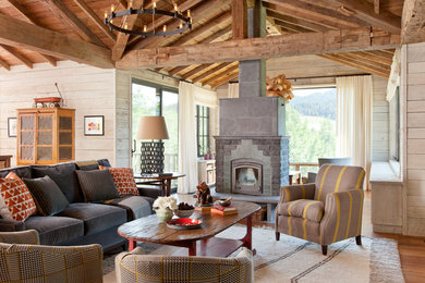 This is an example of a country open concept living room in Other with a wood stove.