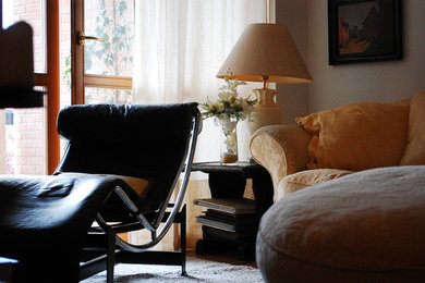 Living room - mid-sized modern formal and enclosed living room idea in Other with beige walls, no fireplace and a tv stand