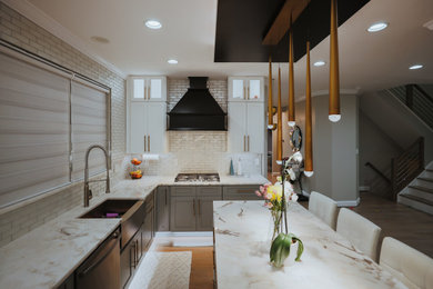 Mid-sized minimalist l-shaped dark wood floor and brown floor kitchen photo in DC Metro with a drop-in sink, beaded inset cabinets, gray cabinets, white backsplash, ceramic backsplash, stainless steel appliances, an island and white countertops